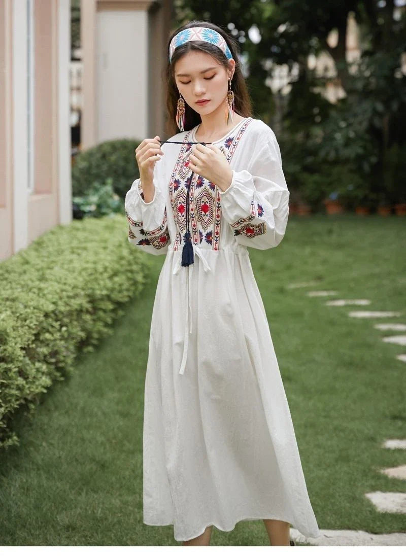 Elegant embroidered cotton-linen dress with tassels, featuring a waist-cinching A-line silhouette in vibrant colors