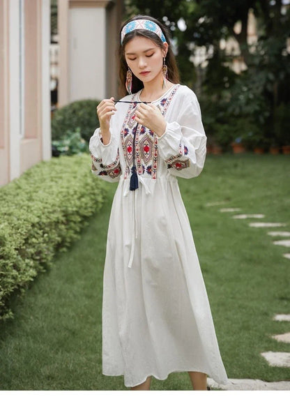 Elegant embroidered cotton-linen dress with tassels, featuring a waist-cinching A-line silhouette in vibrant colors