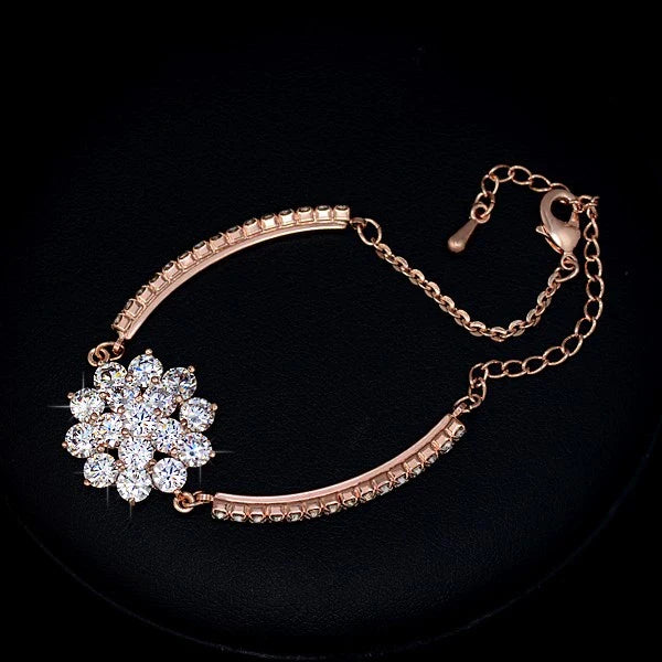 Elegant rose gold cubic zirconia bracelet with intricate cross, crown, and Roman numeral design