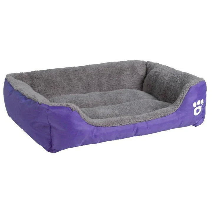 A plush, green pet bed with a paw-print pattern, designed to provide cozy and waterproof comfort for pets.