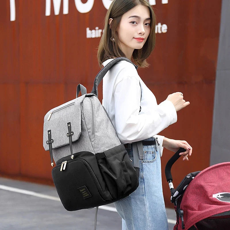 Premium diaper backpack with insulated pockets, stroller attachment, and USB charging port