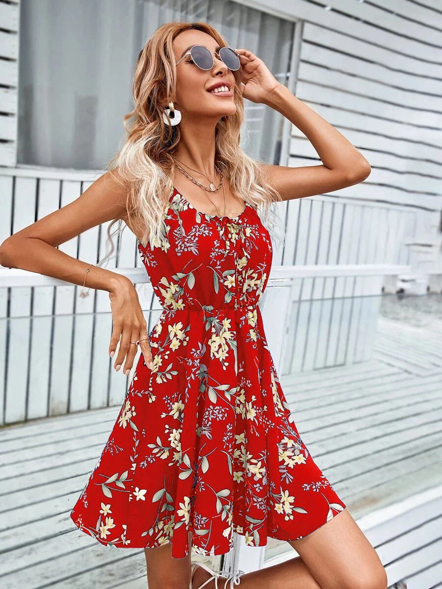 A stylish floral print suspender dress with an elastic waist, perfect for summer fashion and casual or dressy occasions.