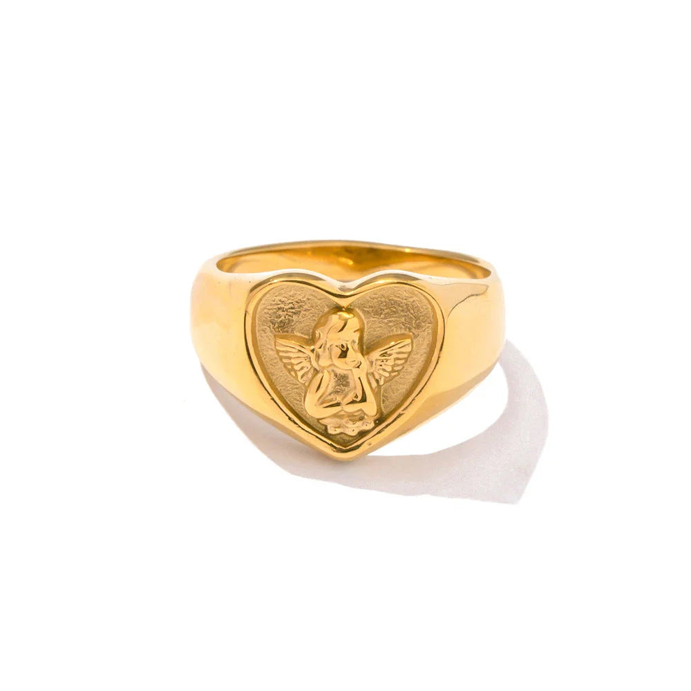 Sophisticated gold-plated stainless steel ring with a geometric heart and angel design, perfect for adding a touch of elegance to any outfit.