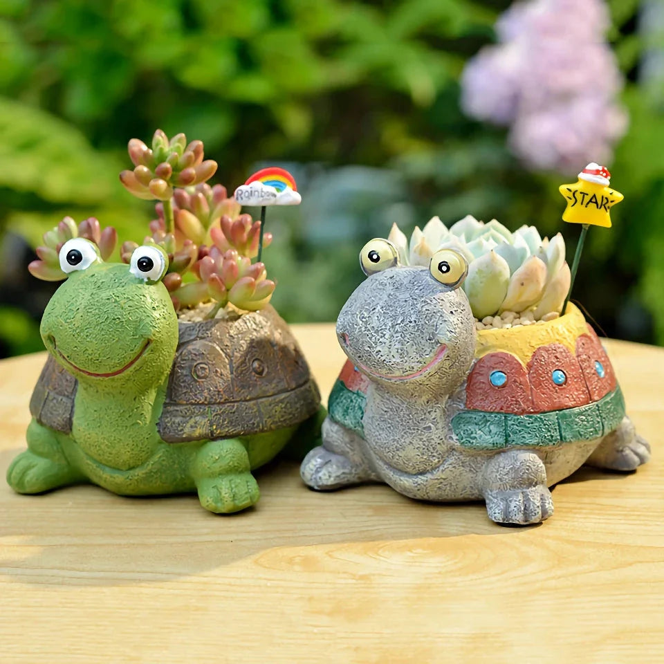 Charming gray cartoon turtle planter holding small potted succulents and cacti
