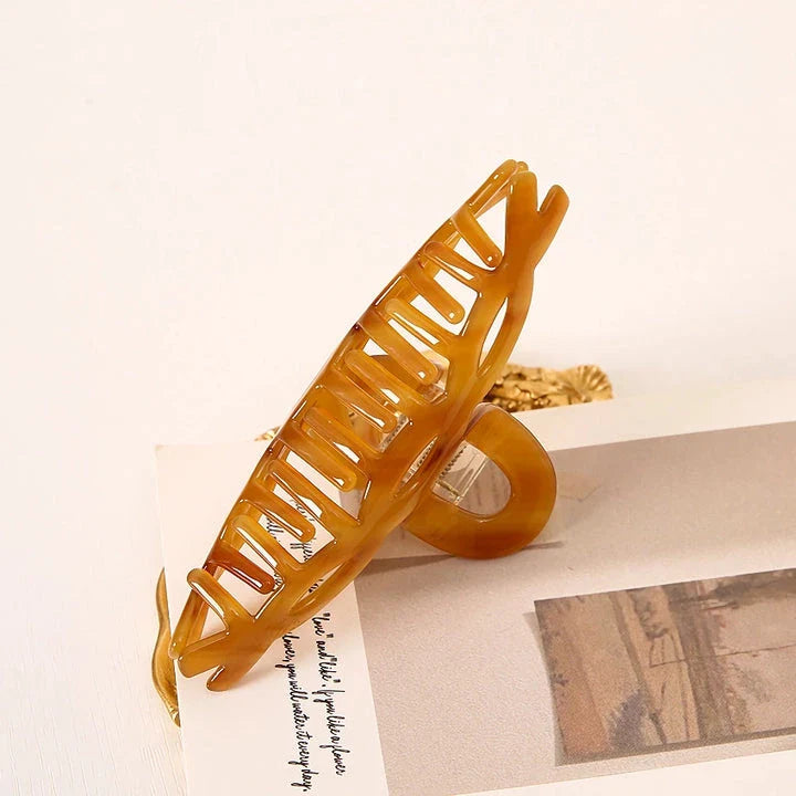 Elegant leopard print large weave hair clip for women and girls, made with durable acrylic and alloy materials for a secure and comfortable hold.