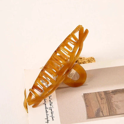 Elegant leopard print large weave hair clip for women and girls, made with durable acrylic and alloy materials for a secure and comfortable hold.