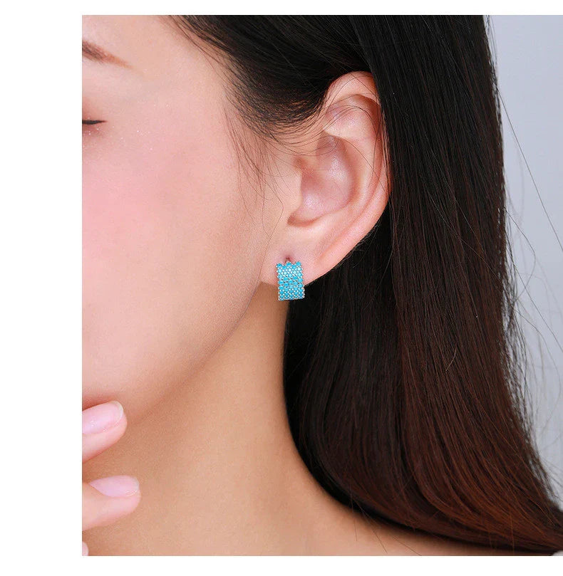 Pair of elegant silver hoop earrings with a micro-insert design, perfect for adding a touch of sophistication to any outfit.