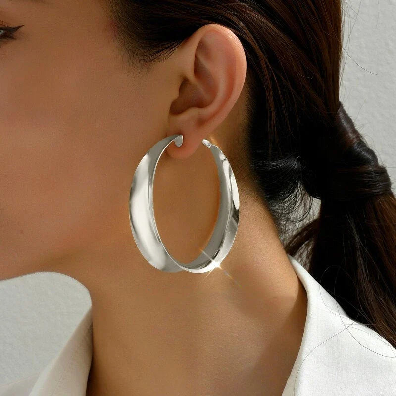 Glossy geometric metal hoop earrings in a silver finish, a trendy and versatile fashion accessory
