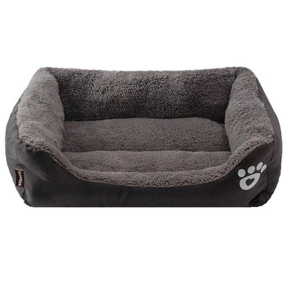 A plush, green pet bed with a paw-print pattern, designed to provide cozy and waterproof comfort for pets.