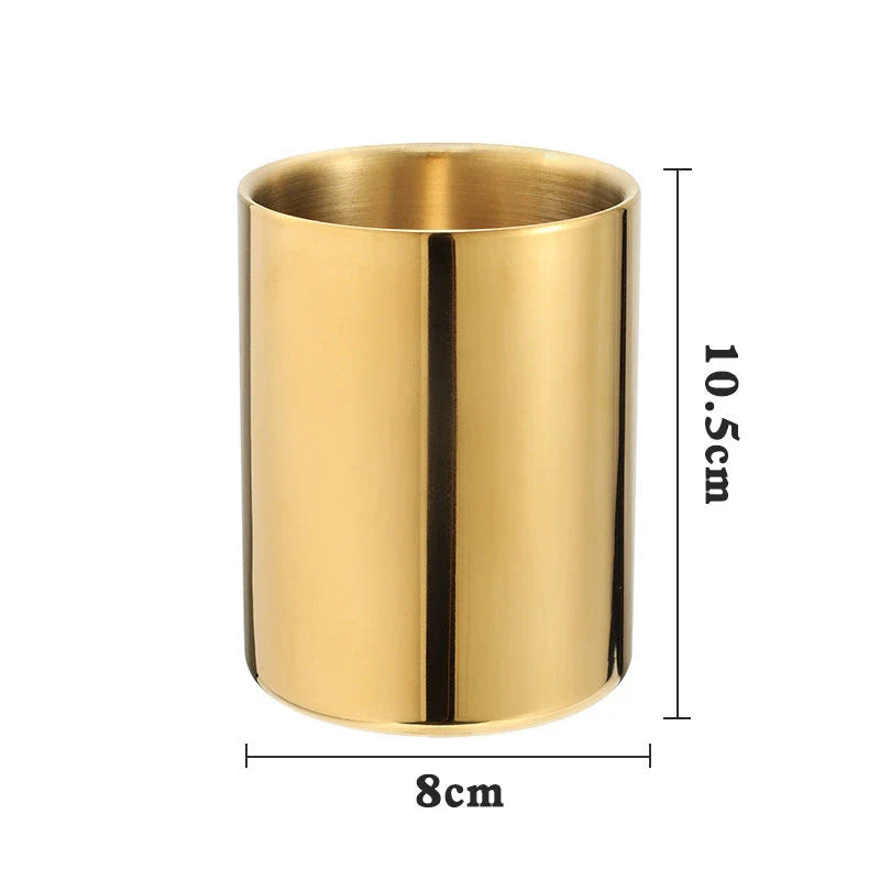 Elegant gold stainless steel desk organizer holding pens, pencils, and makeup brushes on a modern workspace
