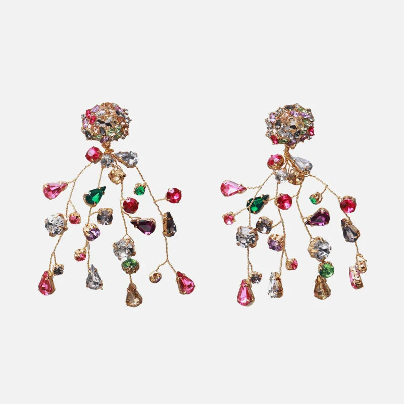 Closeup of a pair of colorful diamond and crystal earrings with a vibrant, retro-inspired design