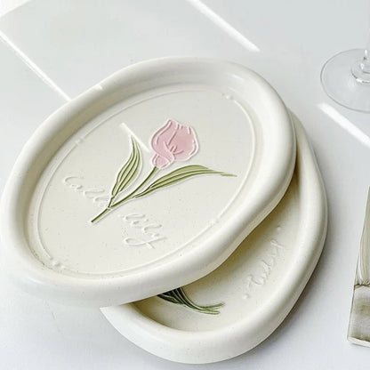 Elegant ceramic plate featuring a delicate floral relief design of Calla Lily and Tulip flowers, perfect for refined dining
