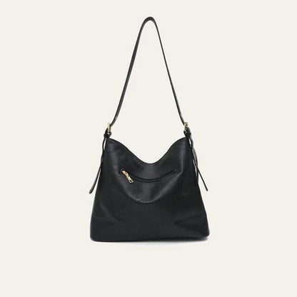Chic vegan leather shoulder bag with tassel decoration, featuring a spacious interior and versatile carrying options