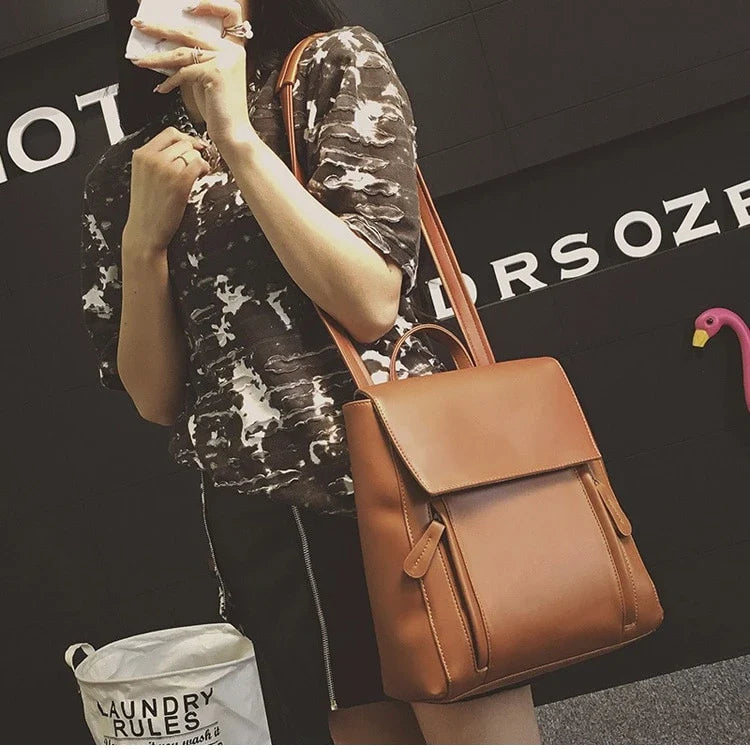 Versatile British-inspired shoulder bag made from high-quality PU leather with a spacious main compartment, convenient pockets, and an adjustable strap