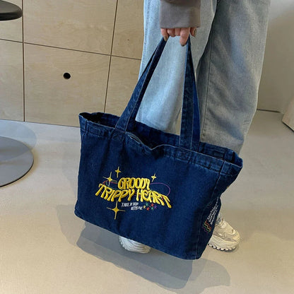 A stylish denim shoulder bag with embroidered details, perfect for everyday use and carrying all your essentials