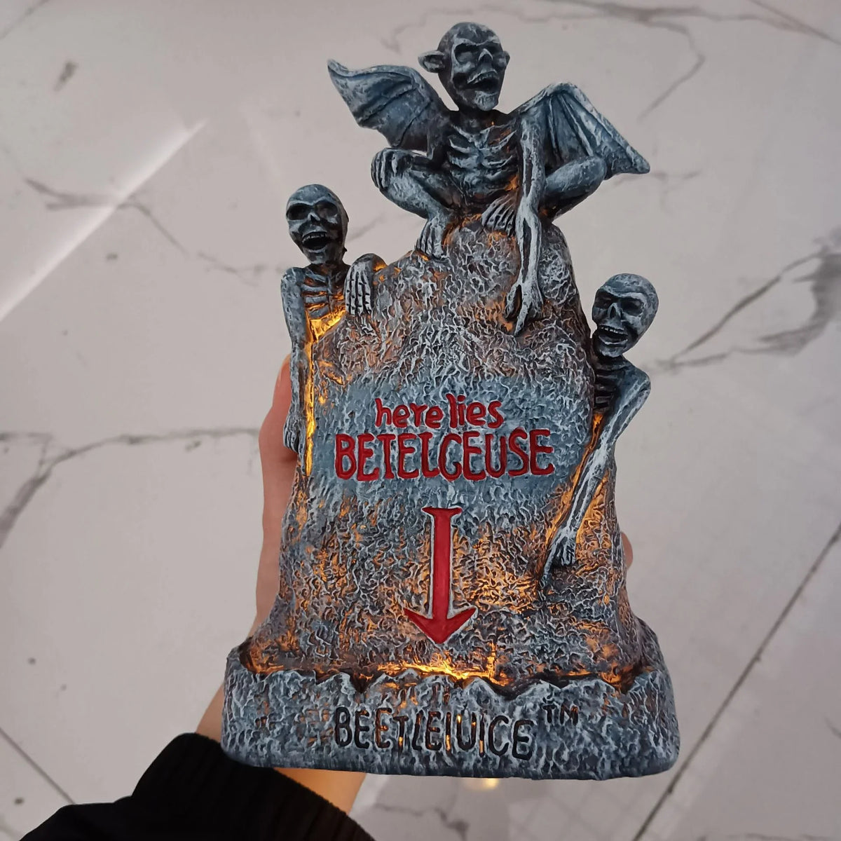 Glowing ghost skull tombstone decor with a spooky, otherworldly glow for Halloween