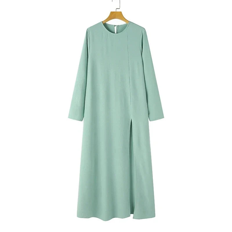 Elegant polyester dress with long sleeves, high slit hem, and available in caramel, black, blue, green, and pink colors