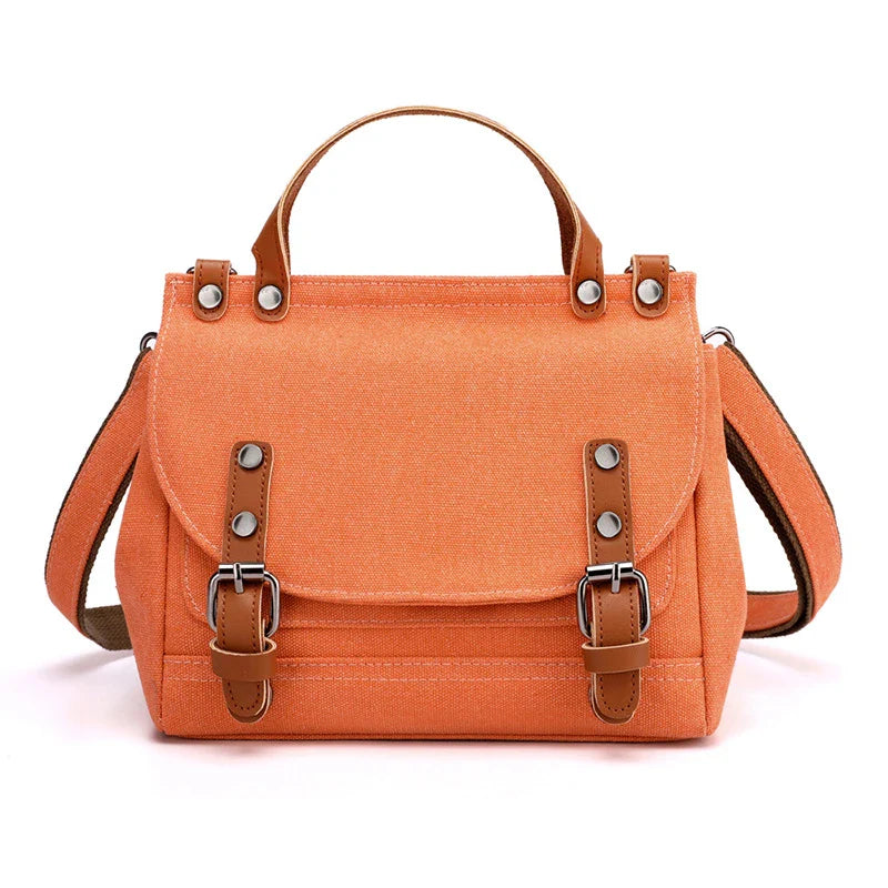 A stylish women's canvas crossbody handbag in an orange color, featuring a small square shape and a horizontal design.