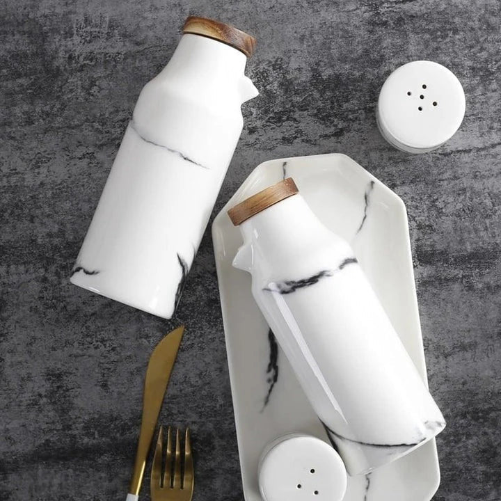 Elegant ceramic salt and pepper oil bottle set with wooden lids, perfect for storing and displaying seasonings and cooking oils in a modern kitchen