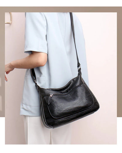 Stylish one-shoulder messenger bag in various colors with a soft, supple PU leather exterior and a spacious, organized main compartment