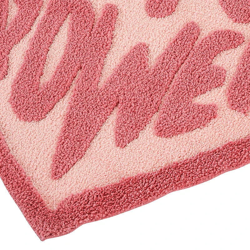 Cozy pink heart-shaped tufted rug with 'GRL PWR' message, perfect for girls' rooms, dressing rooms, and bathrooms