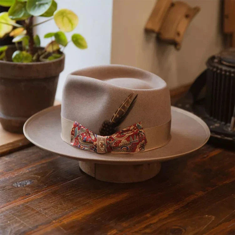 A beige wool top hat with a conical crown design, providing a classic and sophisticated look for formal and casual wear.