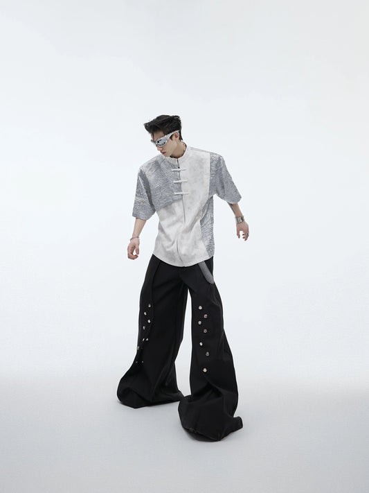 A black and white t-shirt with padded shoulders and a buckle design, offering a relaxed and comfortable fit.