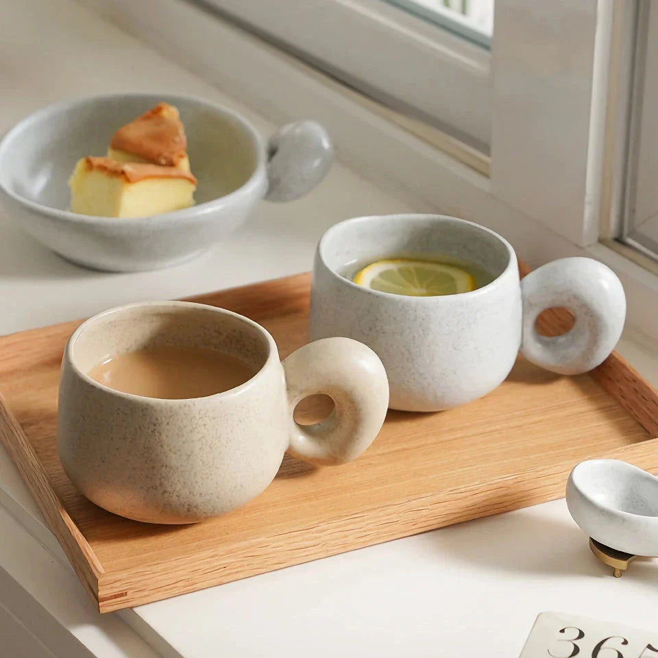 Handcrafted Japanese stoneware retro coffee mug in apricot and grey colors with a comfortable grip and minimalist design
