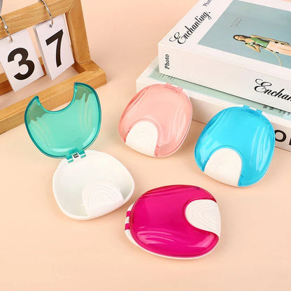 Compact, transparent dental retainer storage box with a push-to-open mechanism for easy access to dental appliances