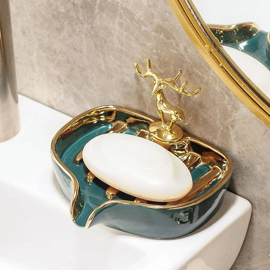 A white gold ceramic soap dish with a drainage design, showcasing a sleek and elegant bathroom accessory.