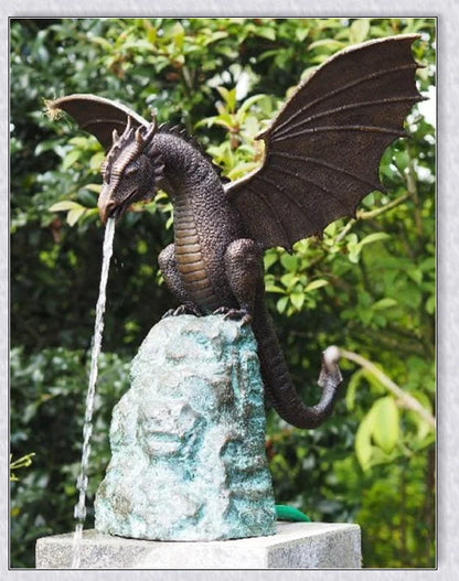 Precision-crafted fire-breathing dragon sculpture serving as a captivating water feature in a lush garden setting