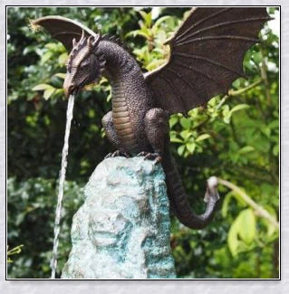 Precision-crafted fire-breathing dragon sculpture serving as a captivating water feature in a lush garden setting
