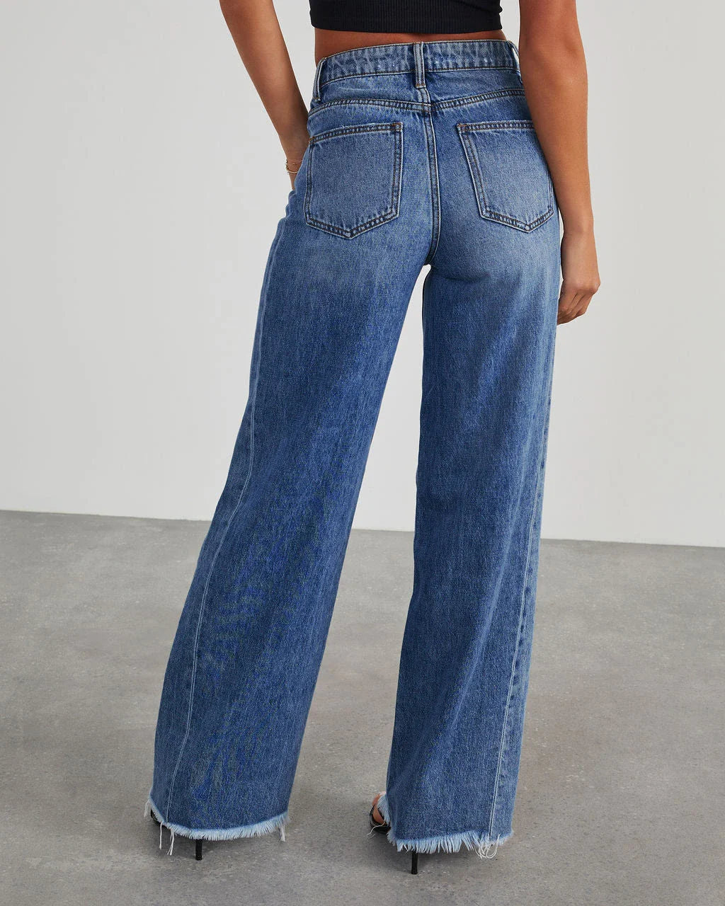 A pair of high-waisted jeans with pockets, designed for a comfortable and stylish fit.