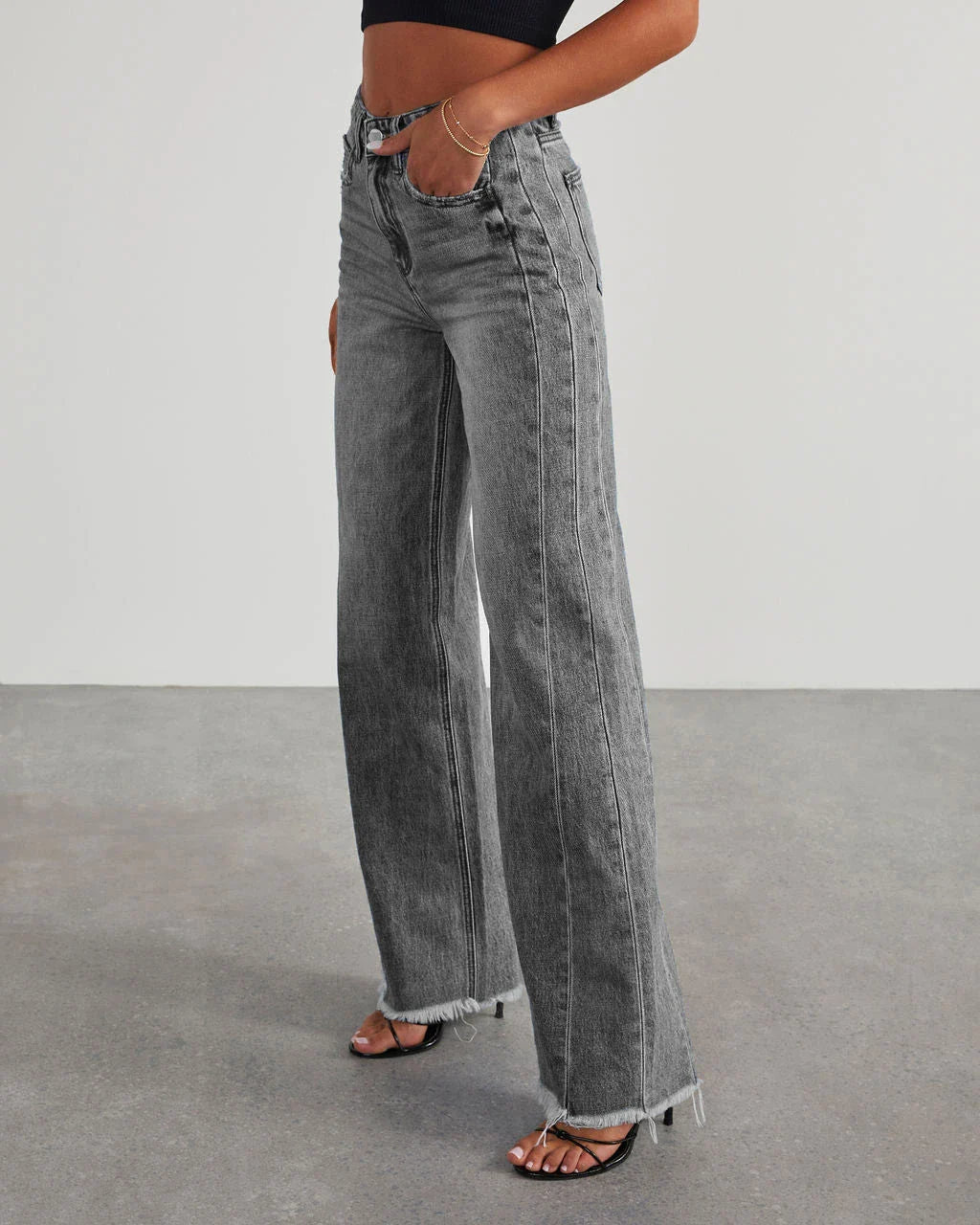 A pair of high-waisted jeans with pockets, designed for a comfortable and stylish fit.
