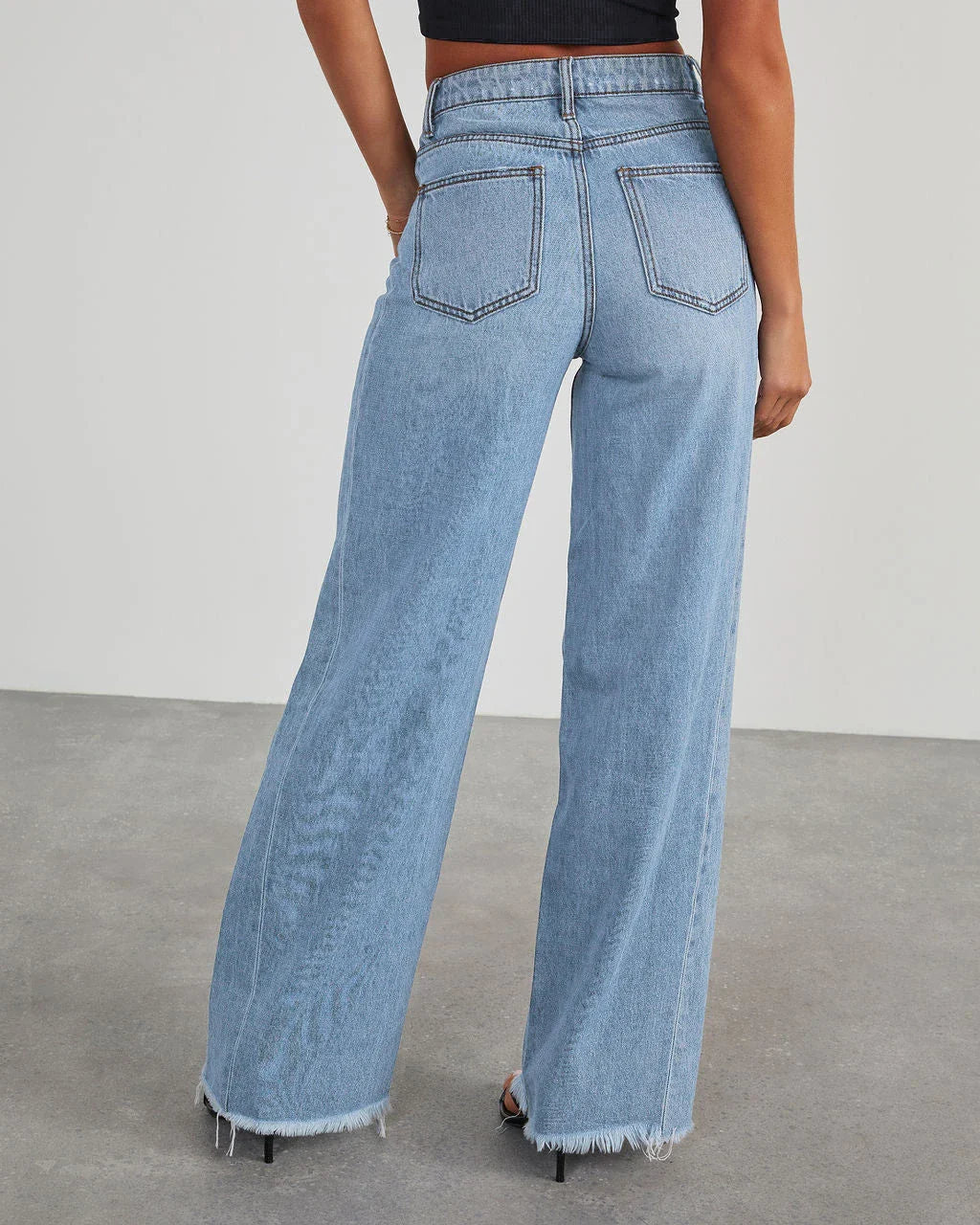 A pair of high-waisted jeans with pockets, designed for a comfortable and stylish fit.