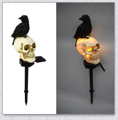 A solar-powered landscape light in the shape of a crow perched on a skull, providing an eerie and captivating outdoor decoration.