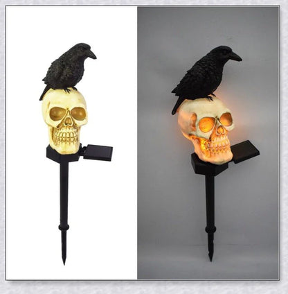 A solar-powered landscape light in the shape of a crow perched on a skull, providing an eerie and captivating outdoor decoration.