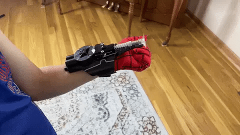 A high-quality 3D printed Spider Web Shooter toy with rechargeable battery and effective shooting range up to 9.8 feet, perfect for superhero roleplay and active fun.