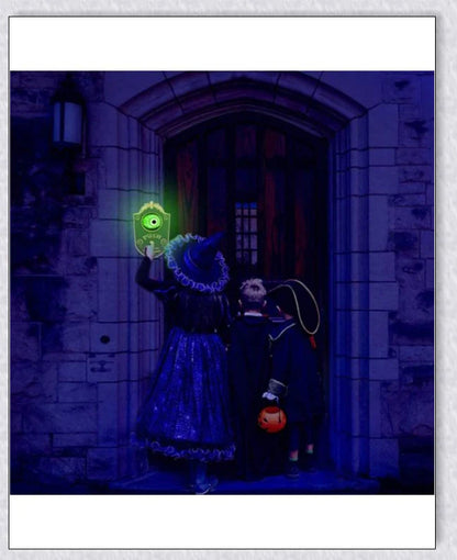 A black, retro-style doorbell with a glowing, moving eyeball that delivers spooky greetings for Halloween and other occasions