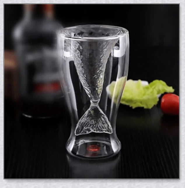 Transparent glass mug with a mermaid tail design, available in blue, green, pink, and yellow colors