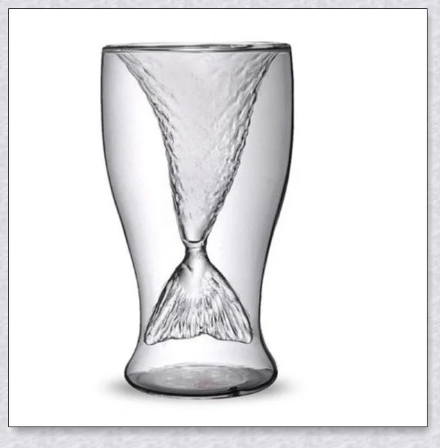 Transparent glass mug with a mermaid tail design, available in blue, green, pink, and yellow colors