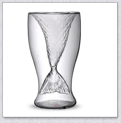 Transparent glass mug with a mermaid tail design, available in blue, green, pink, and yellow colors