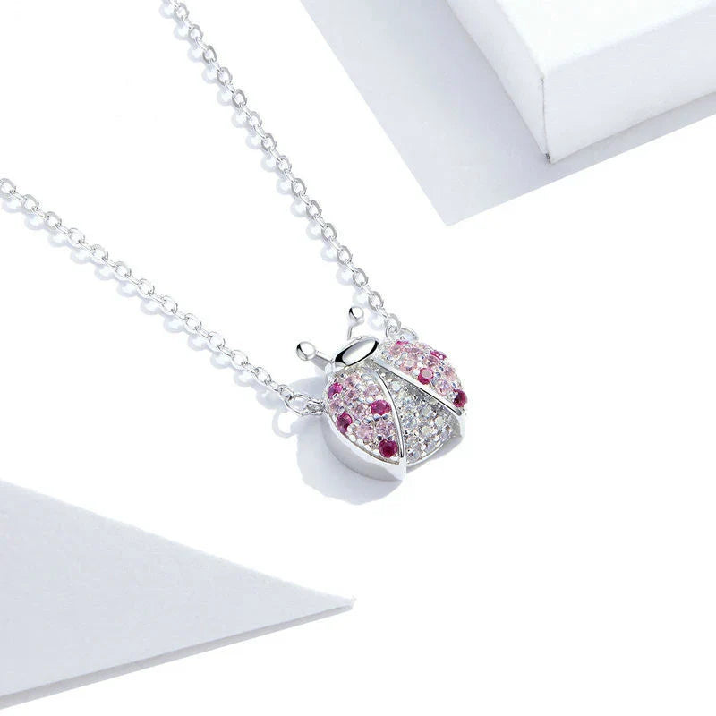 A sterling silver necklace featuring a charming ladybug design, with an adjustable chain for a customized fit.