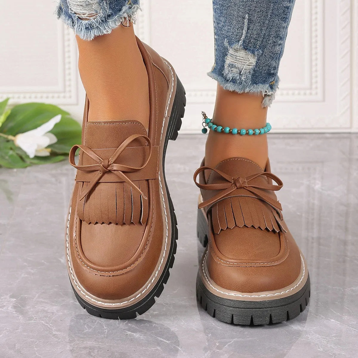 Women's black plus size loafers with tassel, bowknot, chunky heel, and rubber sole
