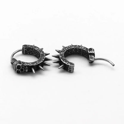 A pair of black vintage-style dangle earrings shaped like detailed motorcycles with a copper tone, on a white background.