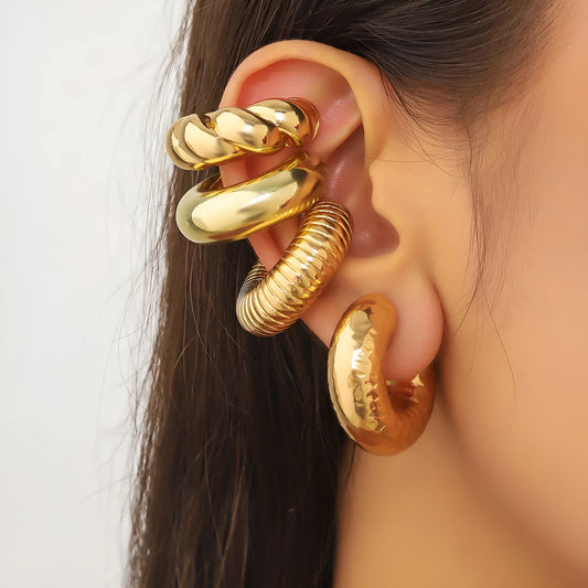 Set of four geometric gold and silver clip-on earrings for non-pierced ears, displayed on a flat surface.