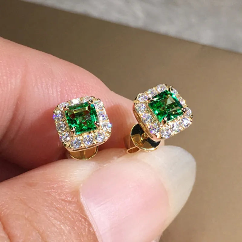 A pair of bright green square zircon stud earrings with a gold electroplated setting on a white background.