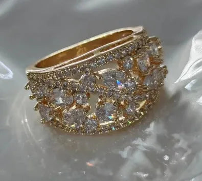 Women's round hollow copper ring showing gold and platinum plating options with sapphire blue and white accents