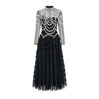 Women's long sleeve black beaded dress with 3D decoration and a mid waist.