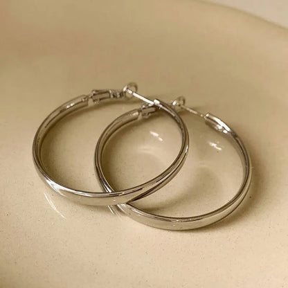 Gold and silver tone 40mm metal circle earrings with electroplated finish